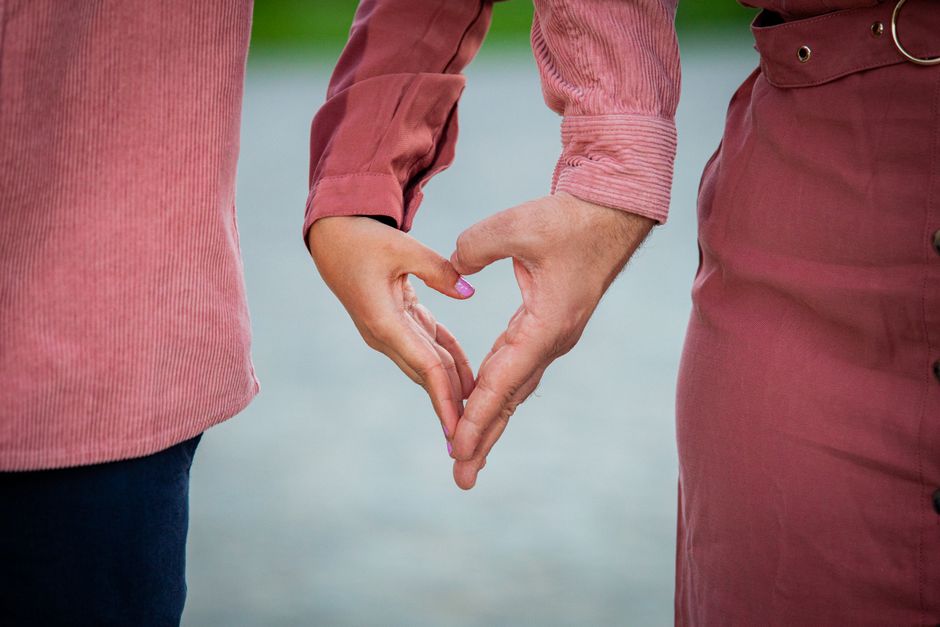 A close-up of hands signing the concept of time against a soft, neutral background