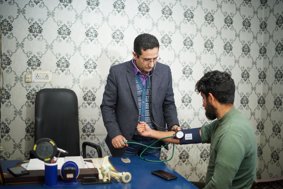 A doctor and a Deaf patient communicating using American Sign Language in a clinic setting